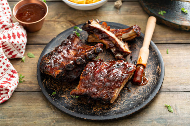 istock Grilled barbeque ribs with BBQ sauce and sides 1351182262