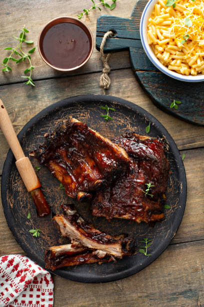 istock Grilled barbeque ribs with BBQ sauce and sides 1351182264