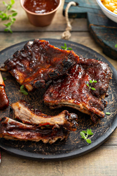 istock Grilled barbeque ribs with BBQ sauce and sides 1351182265