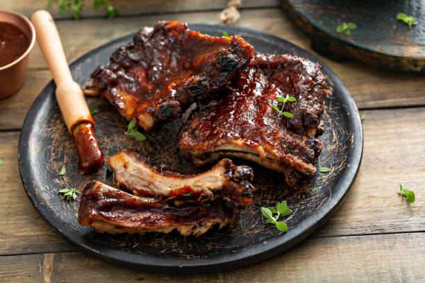 istock Grilled barbeque ribs with BBQ sauce and sides 1351182268