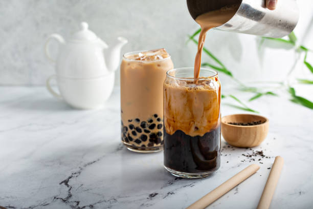 Boba milk tea in a tall glass with ice Boba milk tea with brown sugar syrup in a tall glass with ice on marble table bubble tea photos stock pictures, royalty-free photos & images