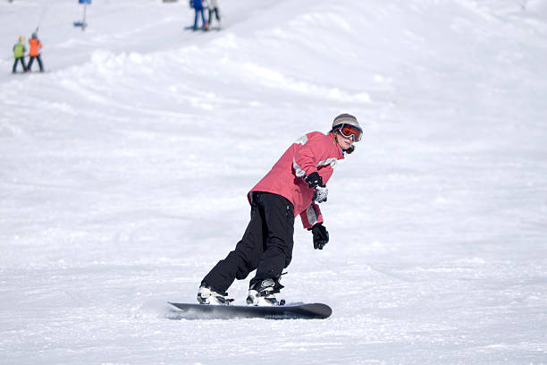 istock Young Woman Snowboarding 135118507
