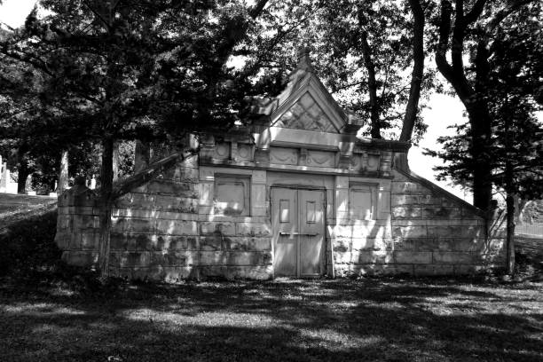 istock empty abandoned cemetery graveyard crypt stone tomb dark spooky horror haunted black white architectural background 1351187342