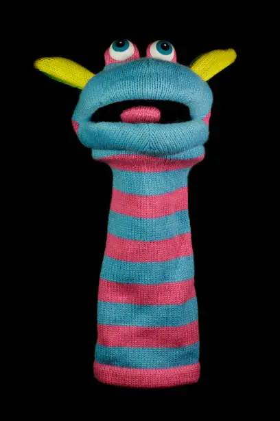 Photo of Sock Puppet Isolated Against Black Background