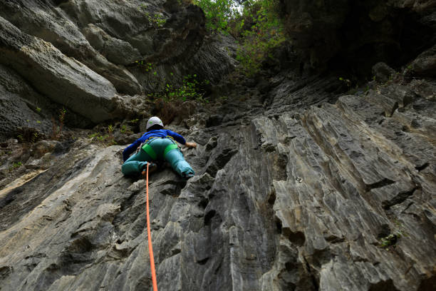istock Female rock climber on cliff 1351193137
