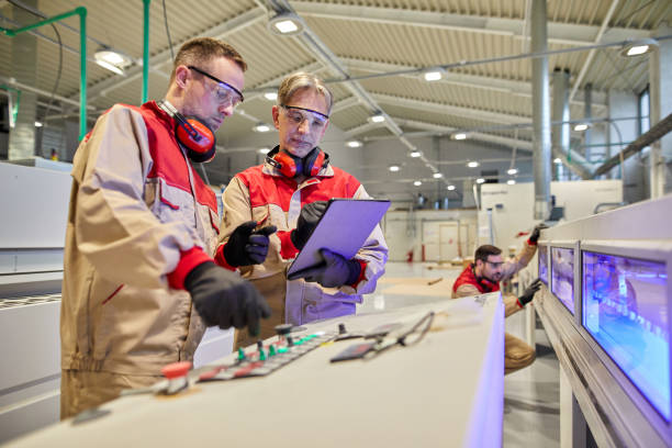 istock Senior manager supervising carpenters during their work in a workshop 1351194080