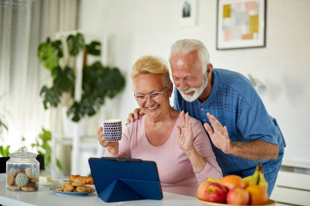 istock Senior couple using digital tablet for video call with family 1351194915