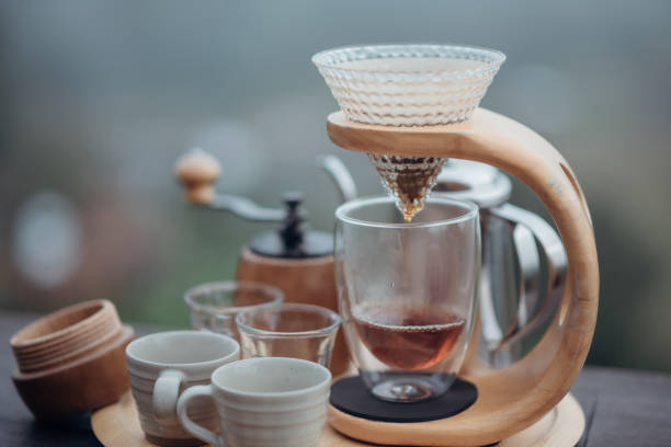 istock A drip coffee set with a Steel kettle, glass, and hand drip coffee maker in minimalist style with the fog and nature background. 1351196751