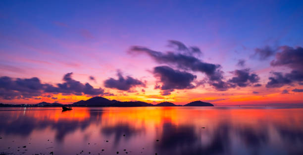 istock Beautiful motion blur long exposure sunset or sunrise with dramatic sky clouds over calm sea in tropical phuket island Amazing nature view and light of nature seascape 1351204858