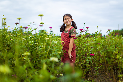 Hispanic girl standing on a flower field