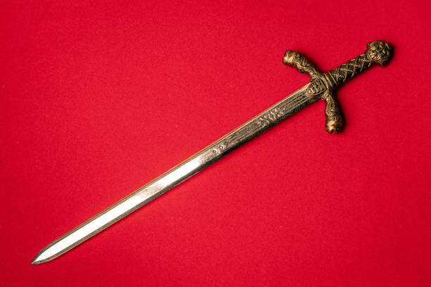 istock Knight sword close-up on a red background. 1351207900