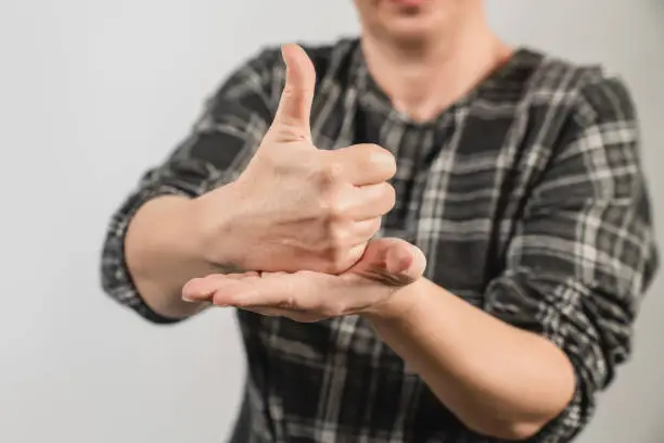 Photo of Deaf woman show her hand for Help or aid as sign language. Deaf body language concept