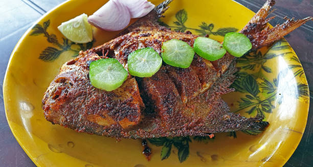 istock Pomfret fry. garnished with salad Diveagar 1351210711