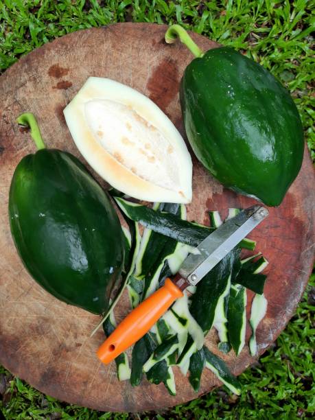 istock Peeling Papaya on cutting board - food preparation. 1351211983