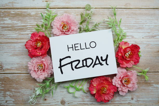 istock Hello Friday text  with Blooming flower on wooden background 1351212242