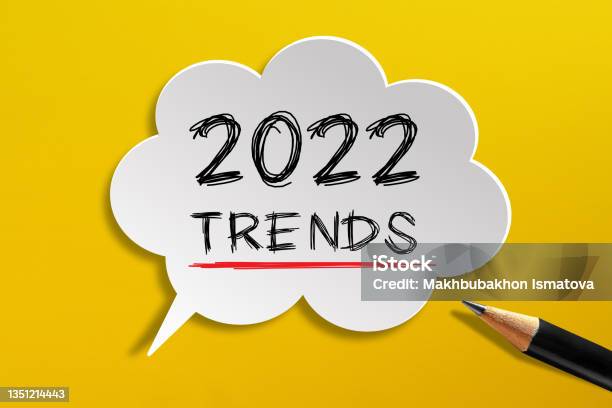 2022 Trends Written On Speech Bubble With Pencil On Yellow Background Stock Photo - Download Image Now