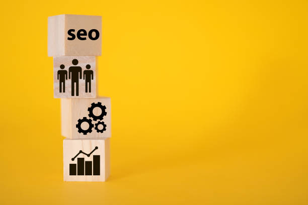 istock SEO on wooden cubes, yellow background, different icons. 1351214752