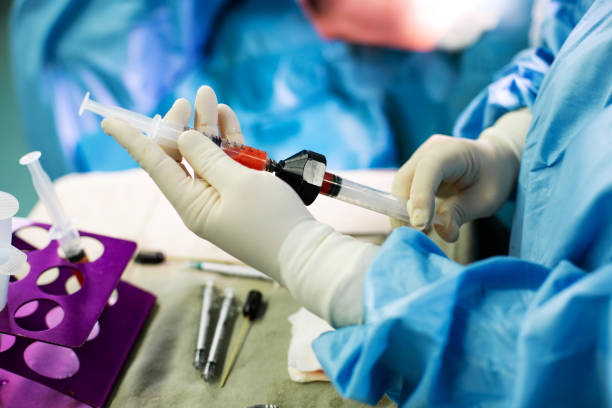 istock Hands Holding Syringe and Transfer Fat with Nano Fat Transfer Tool in Operation Room 1351216503