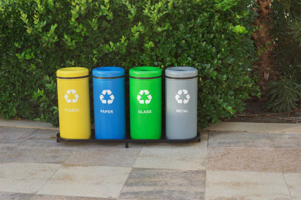 istock Garbage in colored trash cans in the street of the park. (plastic, paper, metal, glass). Sorting garbage by material and type.  Concept of recycling. Environmental protection, ecology. 1351219203