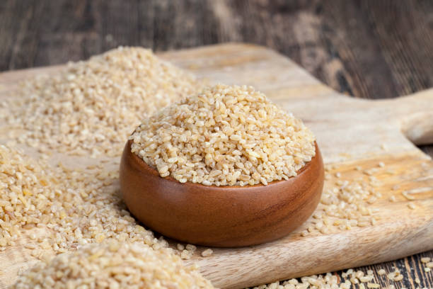 bulgur porridge is made from wheat grain large amount of cereals on a wooden table, bulgur is made from wheat grain, raw bulgur porridge that is not cooking bulgur wheat stock pictures, royalty-free photos & images