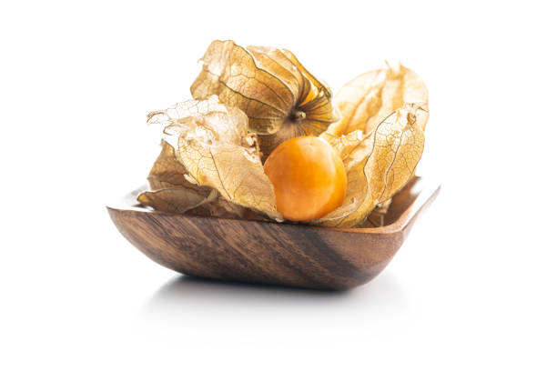 Physalis peruviana. Cape Gooseberry or ground cherries fruit. Physalis peruviana in bowl. Cape Gooseberry or ground cherries fruit isolated on white background. gooseberry cape winter cherry berry fruit stock pictures, royalty-free photos & images