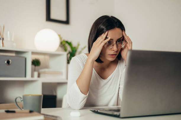 istock Woman feeling tired and stressed while using a laptop and working from home 1351222413
