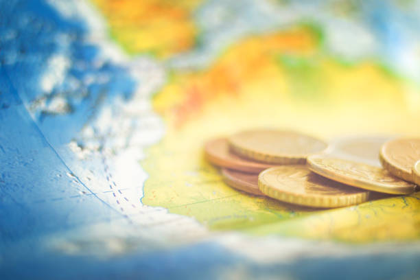 istock Gold coins on the world map 1351225176