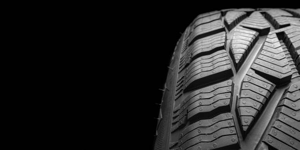 istock black isolation rubber tire, on the black backgrounds 1351225253