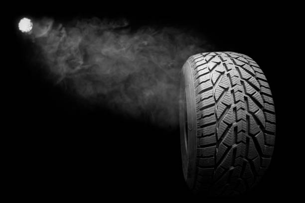istock black isolation rubber tire, on the black backgrounds 1351225259