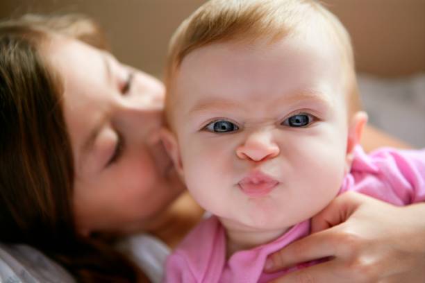 baby girl with funny expression in face stock photo