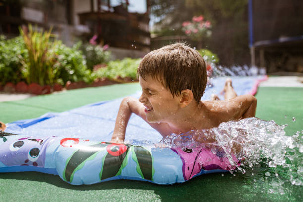 istock Boy having fun on the water slide 1351228391