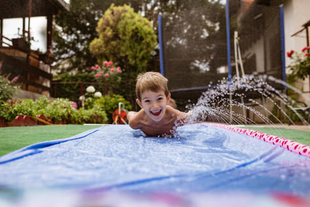 istock Boy having fun on the water slide 1351229593