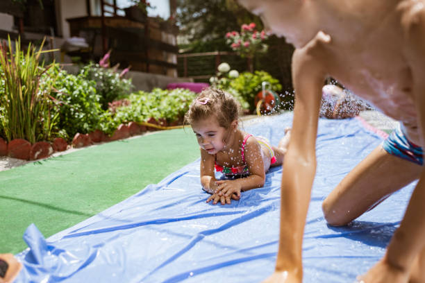 istock Children having fun on the water slide 1351229628