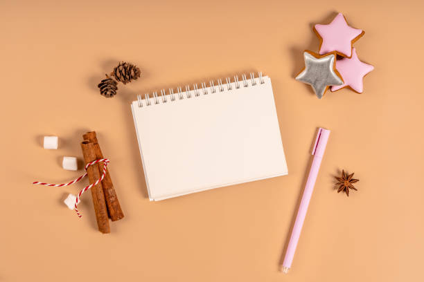 istock Christmas background with blank white notebook surrounded by Christmas decorations. Letter to Santa or Christmas shopping list. Top view, copy space 1351229706