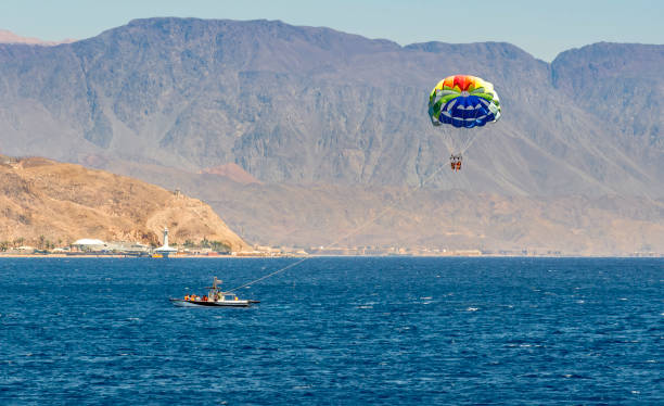 Parasailing in open waters of the Red Sea, Middle East The photo was taken in the Aqaba gulf near Sinai mountains, Middle East parasailing stock pictures, royalty-free photos & images