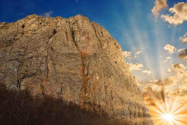 istock mountain in a rays of rising sun 1351231226