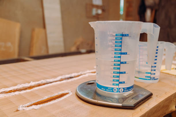istock Liquid cup with epoxy resin on scales 1351231953