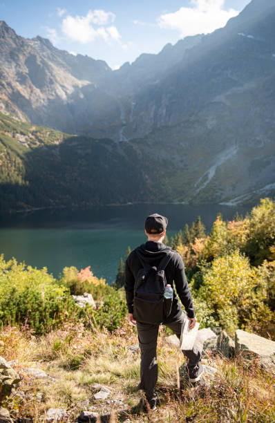 istock Young man traveler with map and backpack 1351233116