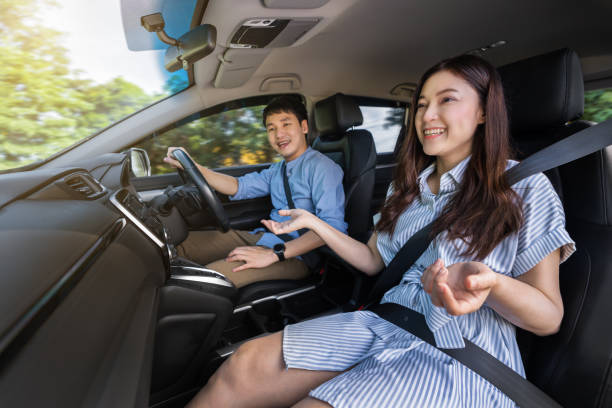 istock happy couple is talking while driving a car 1351233149
