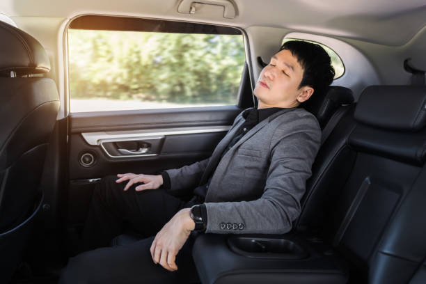istock business man sleeping while sitting in the back seat of car 1351233229