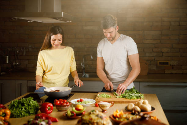 istock Happy couple making lunch in the kitchen. 1351234469