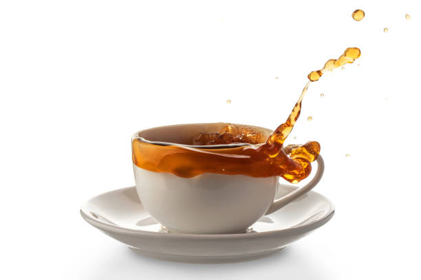 istock white porcelain cup with spilled tea, isolated on a white background 1351234643