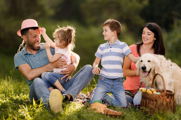 istock Happy family enjoying during picnic day in the park. 1351236708