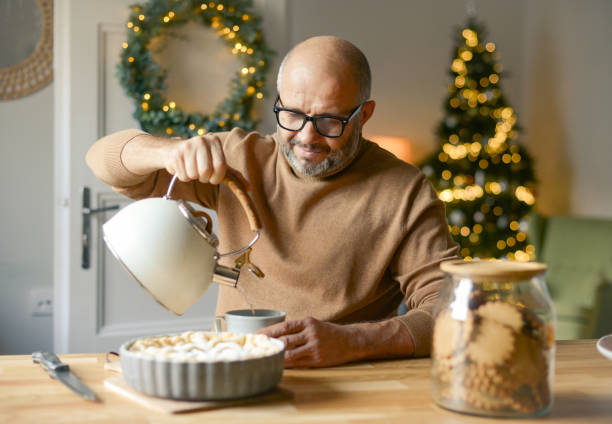 istock mature adult man in christmas home interior ( hot drink) 1351237405