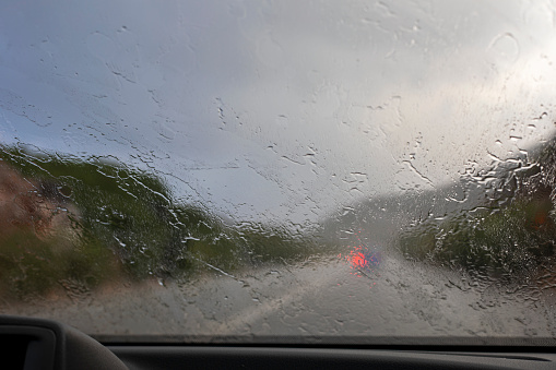 blurred wet windshield traveling by car in a downpour horizontal