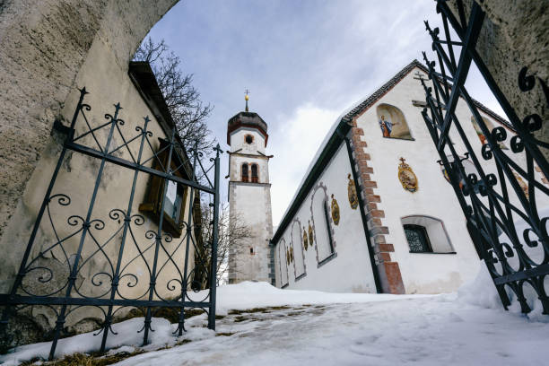 istock Small Austrian church with onion dome in winter landscape, Mieming, Tirol, Austria 1351237609