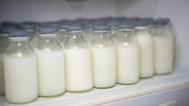 frozen breast milk in the bottles frozen breast milk bottle arrangement in freezer breast milk stock pictures, royalty-free photos & images