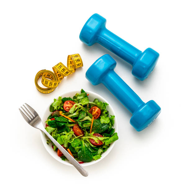 Eating salad and exercising isolated on white background stock photo