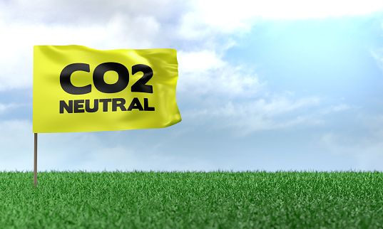 3D Render Carbon Neutrality message on flag on green grass. Sustainability and Environment concept.