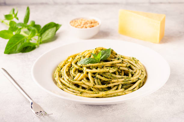 istock Pasta spaghetti with pesto sauce and fresh basil leaves 1351241292
